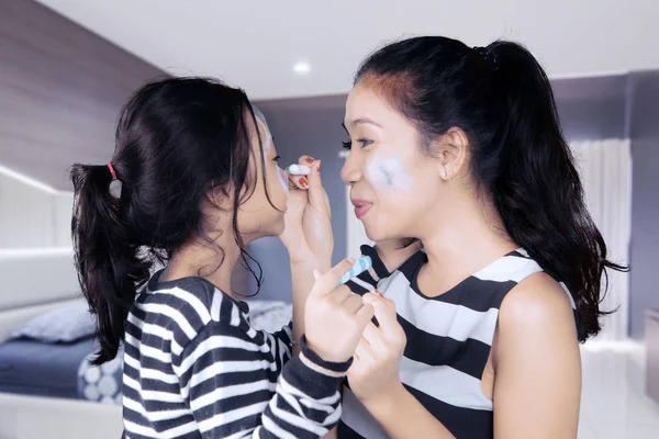 Madre e hija divirtiéndose con la pintura facial —  Fotos de Stock