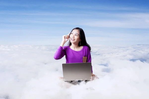 Asian student working with computer laptop on top of clouds — Stock Photo, Image