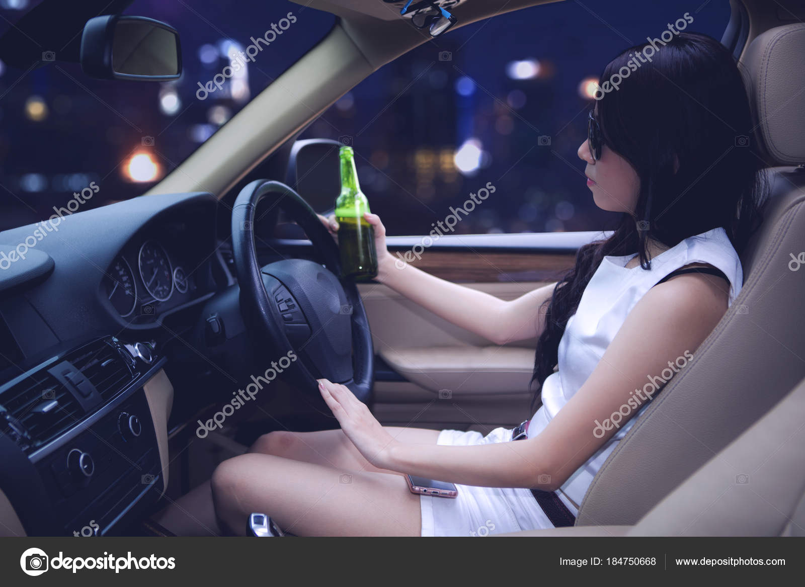 Asian Woman Driving A Car While Holding A Bottle Of Beer Stock Photo By C Realinemedia