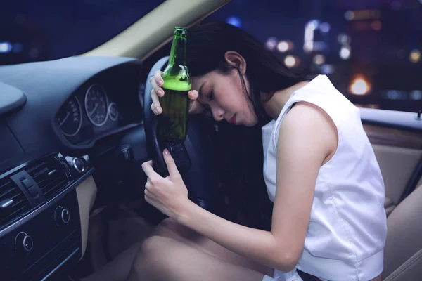 Drunk Asian woman driving a car at night — Stock Photo, Image