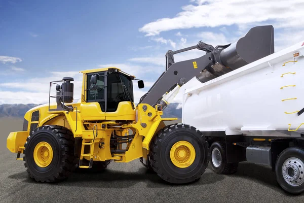 Bagger belädt LKW mit Erde auf Baustelle — Stockfoto