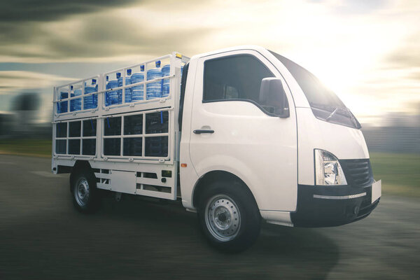 Light commercial truck delivering water gallon parked on the road