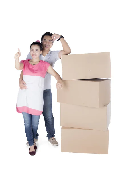 Sweet couple with stack of cardboard boxes — Stock Photo, Image