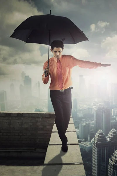 Çatıda şemsiye ile erkek girişimci — Stok fotoğraf
