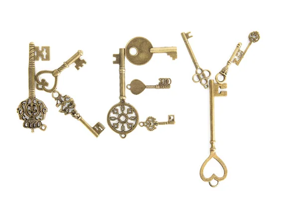 Chaves douradas velhas em forma de palavra-chave — Fotografia de Stock