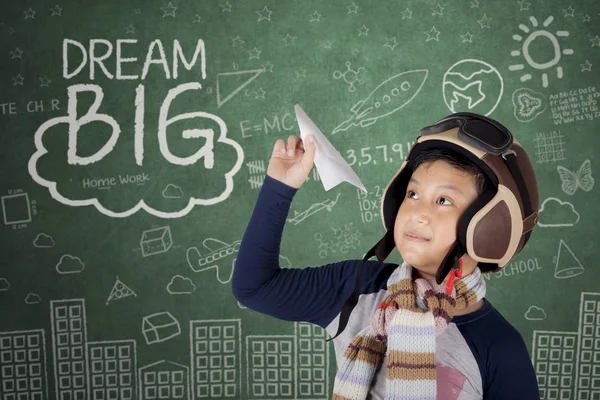 Asian boy wearing vintage flight helmet holding a plane paper — Stock Photo, Image