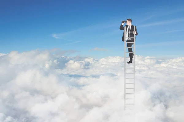 Young businessman with binoculars above cloud — Stock Photo, Image