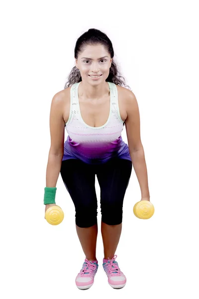 African woman squatting with dumbbells on studio — Stock Photo, Image