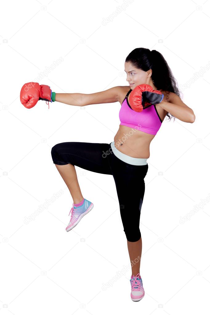 Indian woman exercising boxing on studio