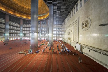 Muslim people doing Salat in the Istiqlal mosque clipart