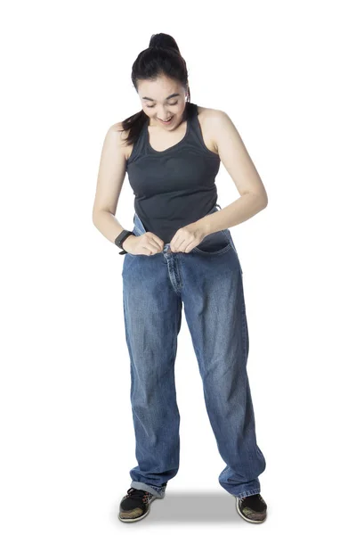 Arabian woman wearing her old jeans on studio — Stock Photo, Image