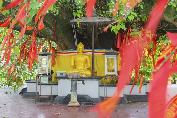 Red Chinese talisman with golden Buddha sculpture — Stock Photo, Image