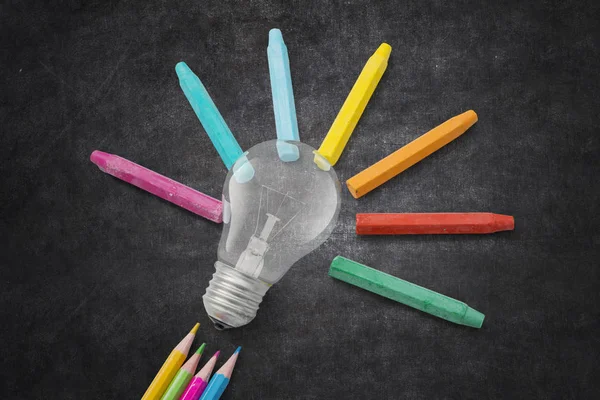 Light bulb and crayon pencils — Stock Photo, Image
