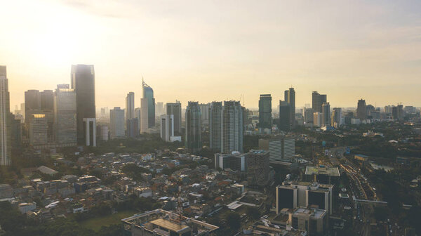 Aerial view of beautiful Jakarta city with skyscraper and residential house at sunset time