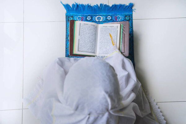 Muslim woman reading holy Quran
