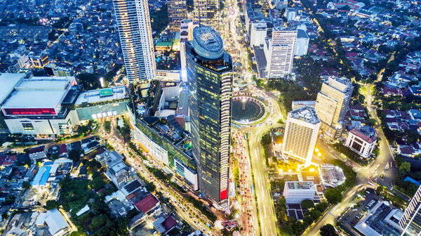 Beautiful aerial view of skyscrapers and Hotel Indonesia roundabout at night with beautiful lights, Jakarta, Indonesia
