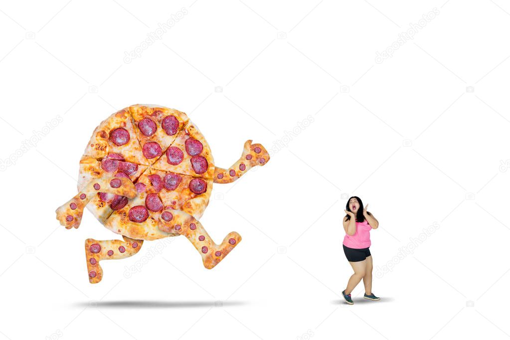 Overweight woman chased by a big pizza