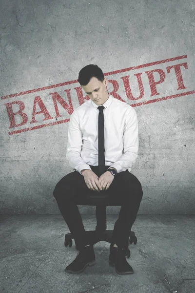 Desperate male entrepreneur with word of bankrupt — Stock Photo, Image