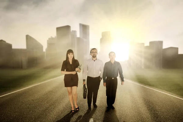 Confident business people walking on the road — Stock Photo, Image