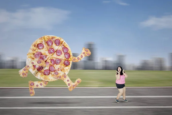 Big pizza chasing obese woman on the track