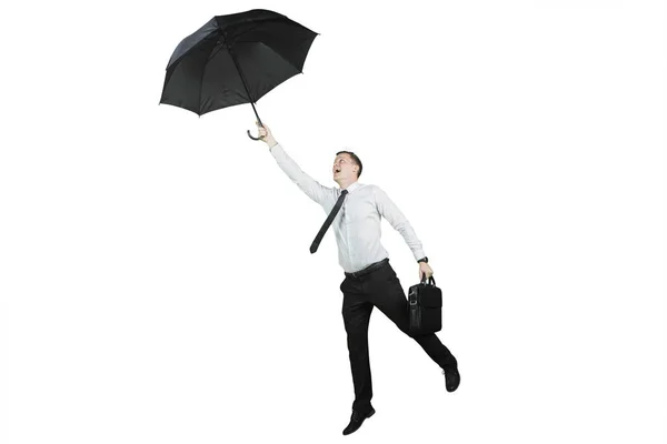 American businessman flying with an umbrella — Stock Photo, Image