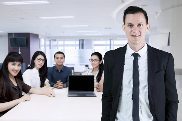 American business leader standing with his team — Stock Photo, Image