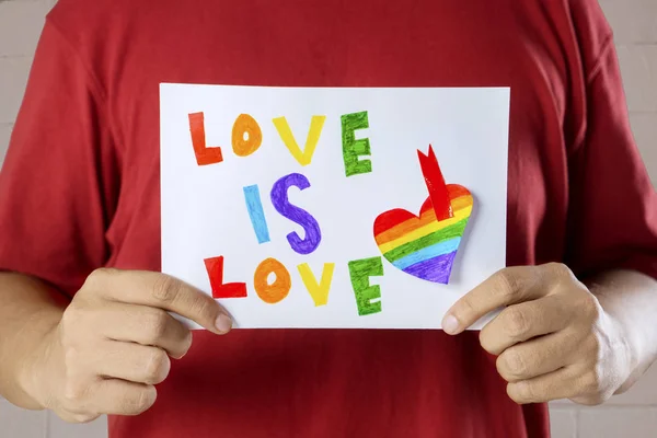 Unknown man holding text of love is love — Stock Photo, Image