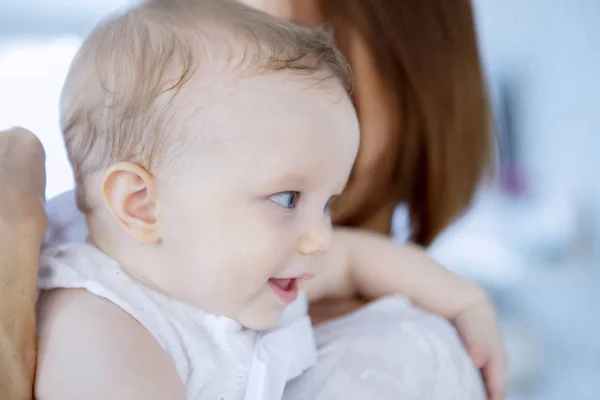 Beautiful baby in a tender embrace of her mother — Stock Photo, Image