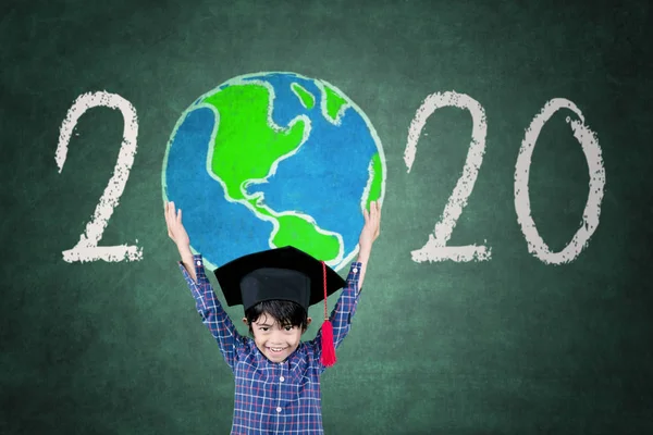 Little bachelor holding a globe with number 2020 — Stock Photo, Image