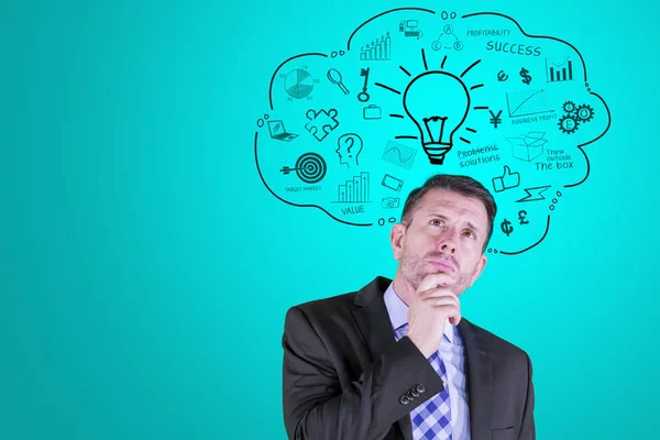 Pensive businessman looking at cribbles over head — Stock fotografie