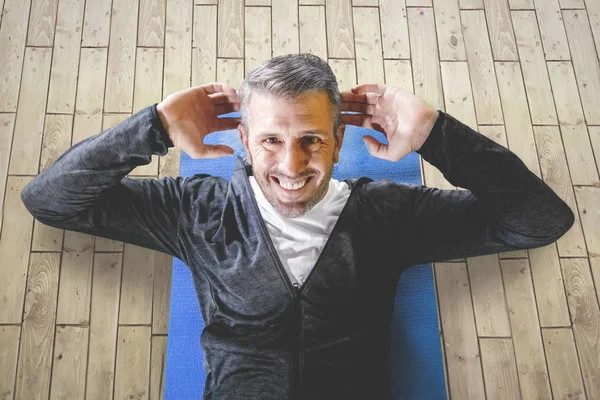 Man workout in fitness center practicing sits up — ストック写真