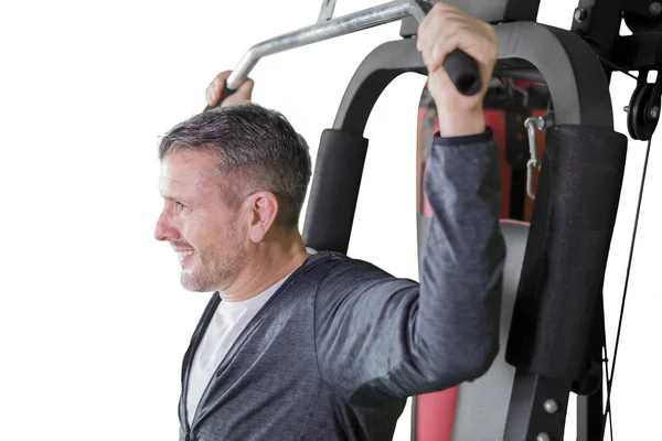 Homme mûr avec machine de fitness en studio — Photo