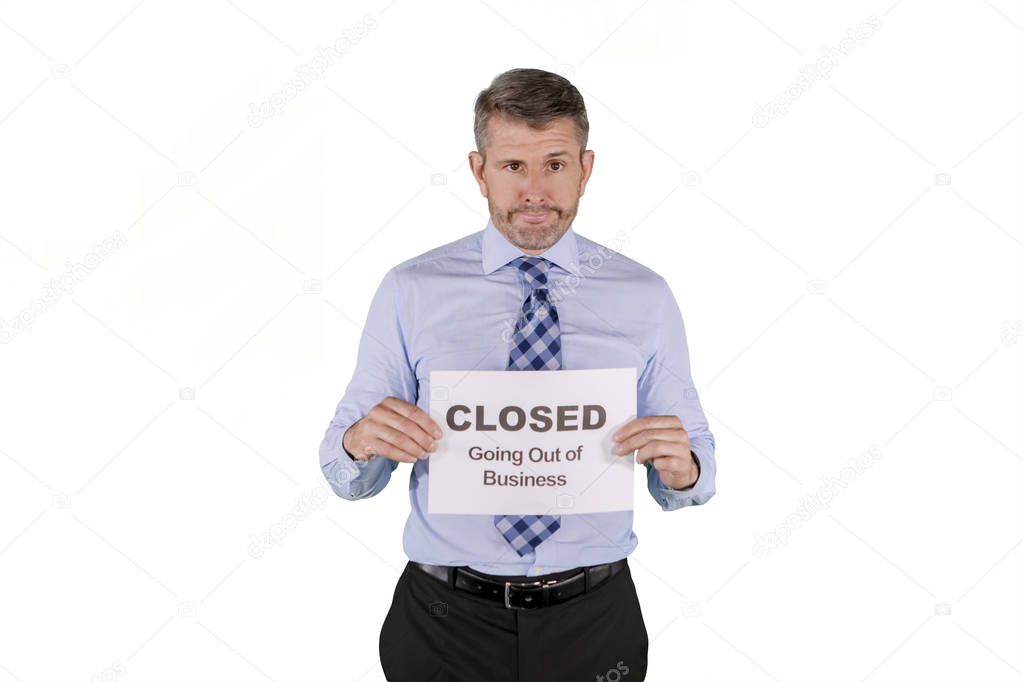 Broke caucasian businessman with out of business sign isolated over white background