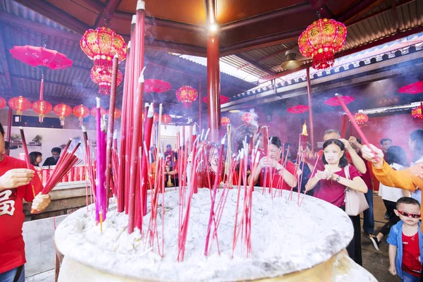 People burning incensed stick in temple — 스톡 사진