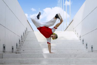 Dancer doing handstand on stairs clipart