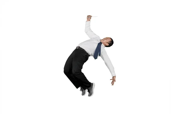 Businessman looking at digital tablet computer while doing some acrobatic moves isolated over white background — Stock Photo, Image