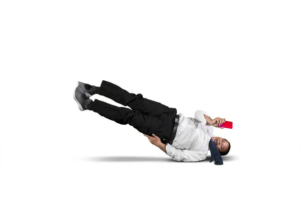Businessman looking at his smart phone while falling — Stock Photo, Image