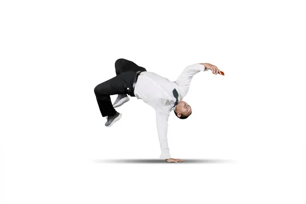 Businessman smiling looking at smart phone while doing some acrobatic moves Royalty Free Stock Images