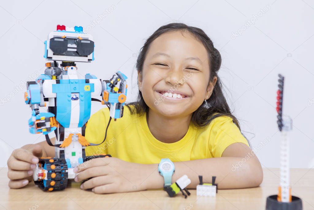 Asian kid presenting her finished robot project
