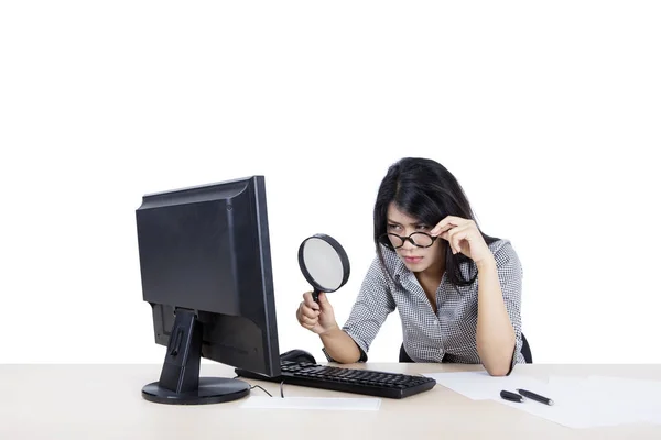 Businesswoman inspecting a file on her desktop — 스톡 사진