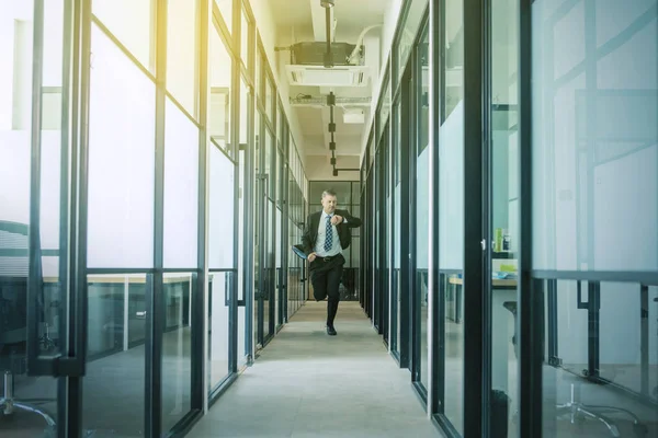Businessman running on the hallway at sunny day — Stock Photo, Image