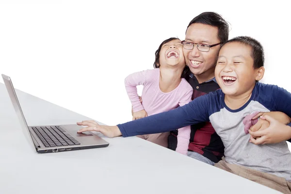 Children laughing while their father guiding them — Stock Photo, Image