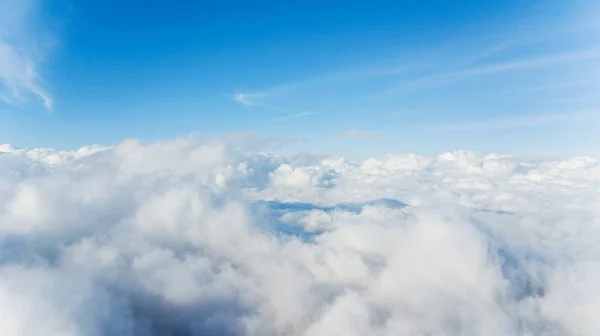 Cumulus clouds covering peaks of a mountain — 스톡 사진