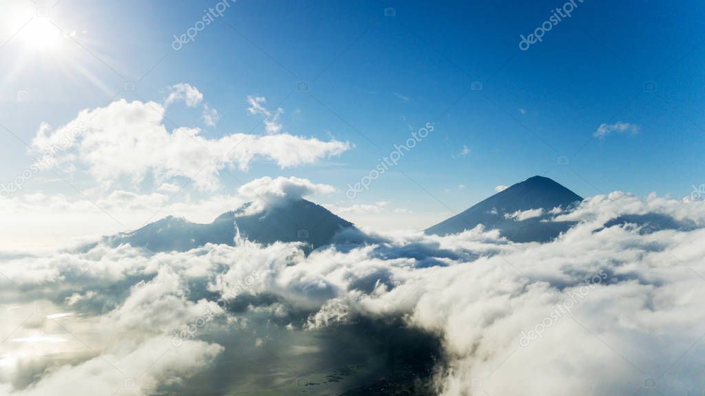Mountain peaks surrounded by cumulus clouds
