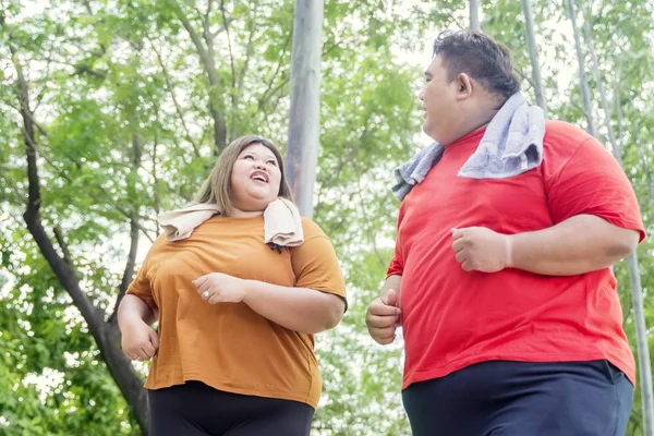 Portrait of fat Asian couple jogging happily — Stock Photo, Image