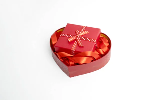 Red ribbons and a valentine gift package — Stock Photo, Image