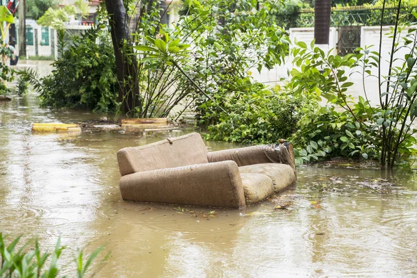 Sofa carried away flood stream in Jakarta city