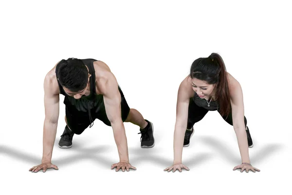 Attractive young couple doing push up together — Stock Photo, Image