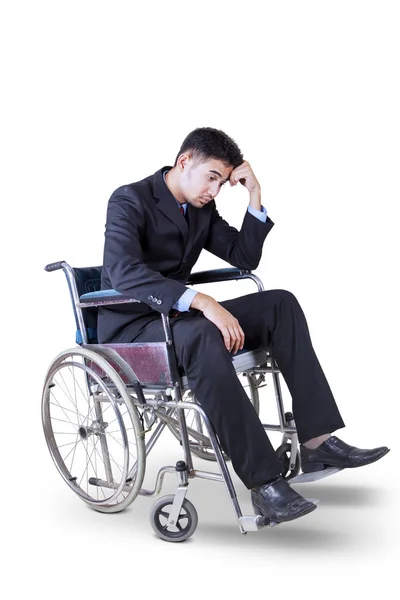 Frustrated businessman sitting on wheelchair — Stock Photo, Image