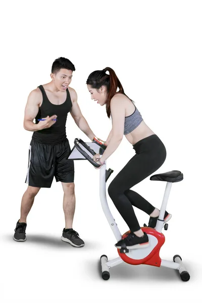 Personal trainer supporting woman doing workout — Stock Photo, Image